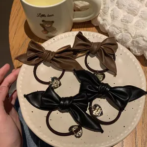 Cute black and brown leather bow hair ties with gold heart charms in a 4-piece set