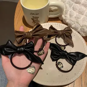 Elegant set of black and brown PU leather bow hair ties with gold heart charms for women