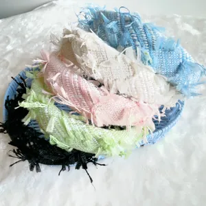 Retro tweed padded headbands in five pastel colors on a soft faux fur background
