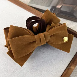 Caramel brown fabric bow hair claw clip with golden metal fashion detail tag