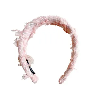 Pink and white tweed headband with fringe edges and soft sponge padding for women
