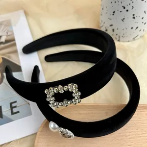 Retro black velvet headband set with elegant rhinestones and pearls for a vintage look