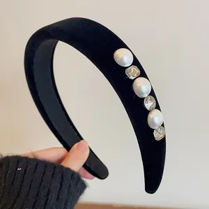 Detail of vintage black velvet headband featuring large pearls and sparkling crystals