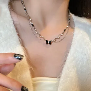 Silver butterfly pearl tassel necklace with double layers shown on neck