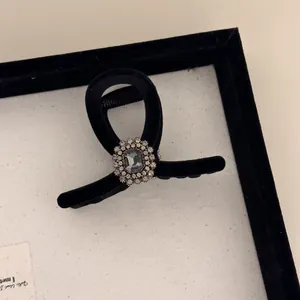 Elegant black velvet hair claw clip with emerald-cut grey gemstone and sparkling rhinestones