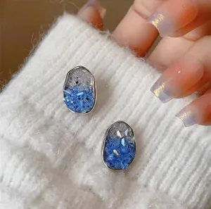 Elegant 925 silver blue crystal earrings with gradient finish and irregular oval design