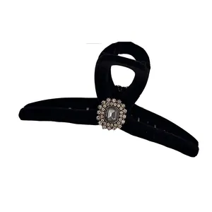 Black flocked claw clip with sunflower rhinestone detail for thick hair on white background