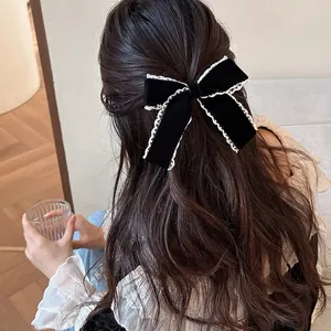Elegant black velvet bow hair clip with white lace trim for vintage aesthetic hairstyles