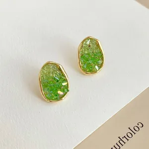 Elegant green crystal stud earrings with gold plating and irregular pebble shape design