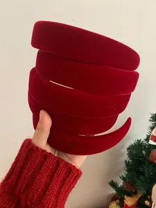 Close-up of stacked red velvet padded headbands showing soft texture and thick design