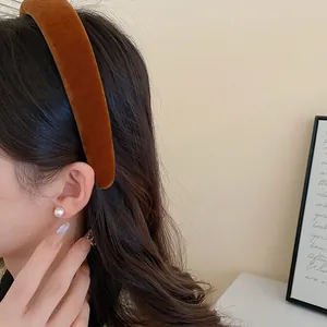 Caramel velvet padded headband on model with white pearl earrings for autumn style