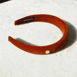 Velvet pumpkin orange padded headband with handmade label and gold metallic detail