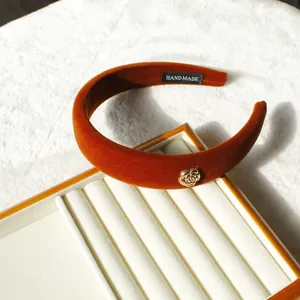 French vintage caramel velvet headband with golden camellia flower accent and high top style