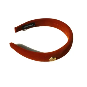 Retro velvet camellia headband in burnt orange with golden rose metal detail