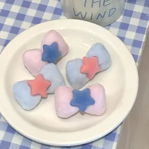 Pink and blue velvet bow hair clips with star accents for women and girls on a plate