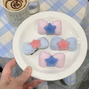 Pink and blue velvet bow hair clips with star charms in a 4-piece set for styling