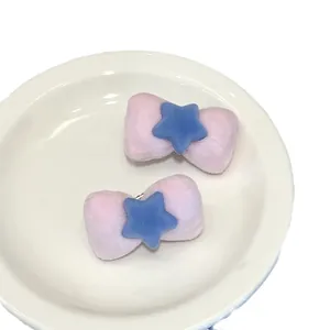 Pair of plush pink bow hair clips with blue stars for girls and women hair styling