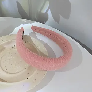 Detailed view of a soft pink bubble-textured wide headband on a ceramic tray