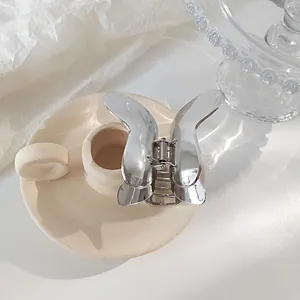Detailed view of elegant silver butterfly hair claw clip on aesthetic tray