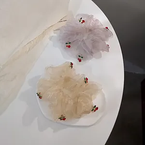 Elegant organza fruit scrunchies with 3D cherry accents in lavender and champagne
