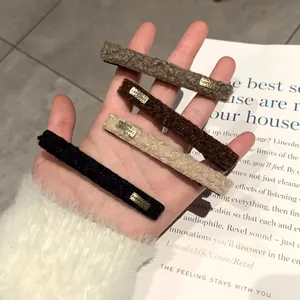 Set of four retro velvet hair clips in brown and beige colors with gold letters