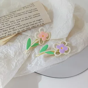 Morandi macaron floral hair clips with pearls and green leaves on white paper