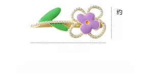Detail of macaron flower hair clip with purple petals, green leaves and small pearls