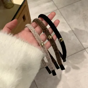 Three-piece plush headband set in black, coffee, and beige with gold metal accents