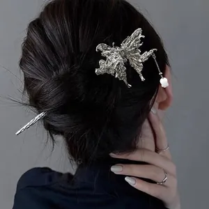 Silver butterfly hair pin with liquid metal texture and pearl tassel on model