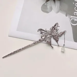 Silver butterfly hair pin with liquid texture, rhinestone center and pearl tassels