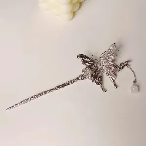 Elegant silver butterfly hair pin with lava texture and pearl tassel on white background