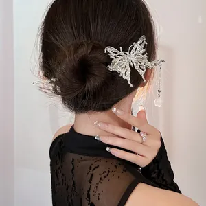 Silver butterfly hair pin with lily of the valley tassel pendant on elegant updo