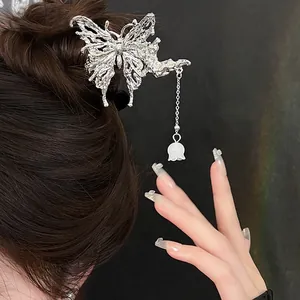Silver butterfly hair clip with liquid metal texture and white lily tassel detail