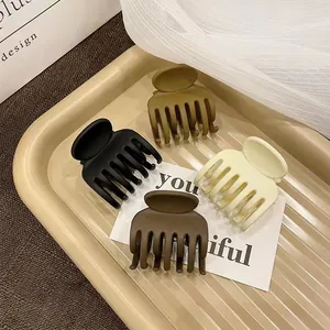Set of 4 matte hair claws in neutral colors like black and green for half-up hairstyles