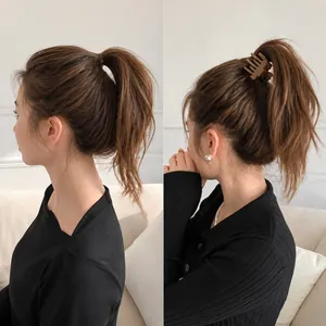 Detail showing deep brown matte hair clip lifting the ponytail for a voluminous look