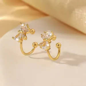 Makrodetail der goldenen Bow-Ear-Cuffs mit Zirkonia-Besatz und polierter Oberfläche