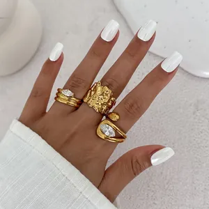 Close-up of gold lava texture rings and marquise zircon accents on a model's hand