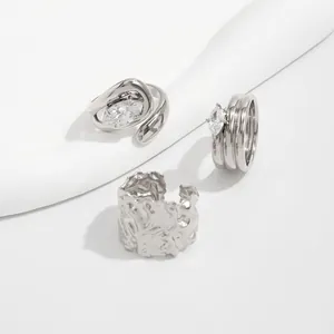 Detailed view of silver rings featuring marquise-cut stones and irregular textures