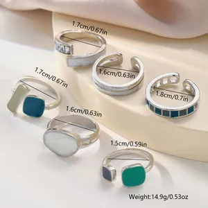 Detail view of 6-piece geometric ring set with colorful enamel and zircon inlays