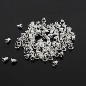 Bulk set of silver bullet-shaped metal earring backs on a glossy black background
