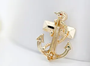 Macro view of golden anchor brooch back showing secure pin fastener and detailed metal craft