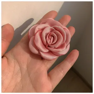 Pink satin rose hair claw clip with elegant 3D layered petals for a French vintage look