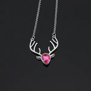 Detailed view of silver deer antler necklace featuring a pink heart crystal pendant