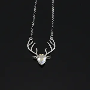 Elegant crystal reindeer head pendant necklace with silver chain on black mirror