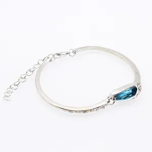 Dettaglio del bracciale argento con un grande cristallo ovale blu e accenti di diamanti