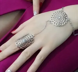 Detail of silver hand harness featuring hollow flower pattern and sparkling rhinestones