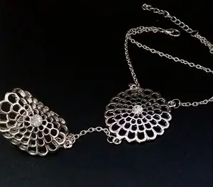 Macro view of adjustable mandala hollow flower ring bracelet set with crystal center