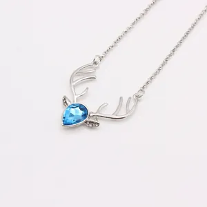 Detail of deer pendant with large faceted blue gemstone and sparkling rhinestone antlers