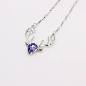 Close-up of reindeer antler pendant with purple teardrop crystal and silver O-chain