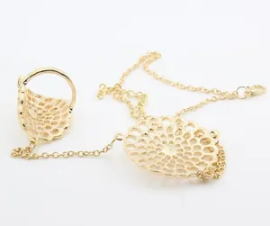 Close-up of golden hollow flower ring bracelet with adjustable lobster clasp detail